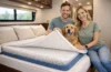 Couple and their dog sitting on a RV mattress mesh