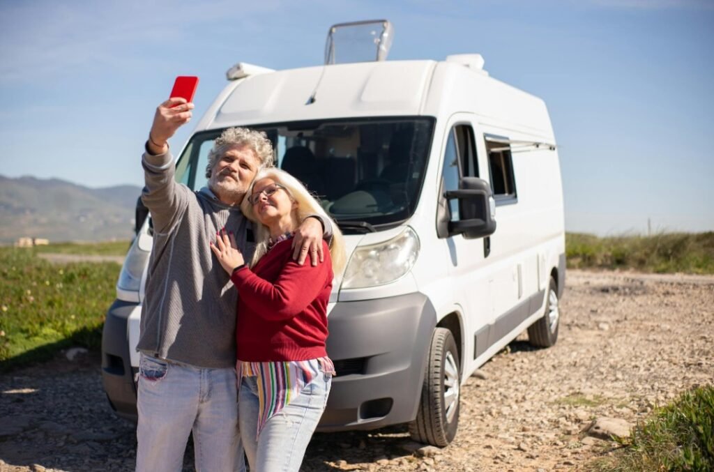 Couple standing in front of an RV